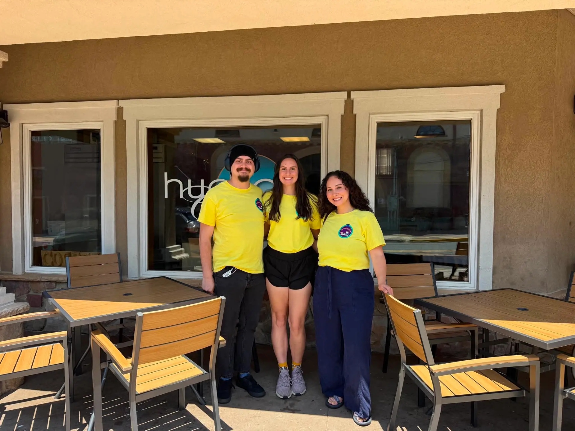The Doo Diligence pet care team in their signature yellow shirts